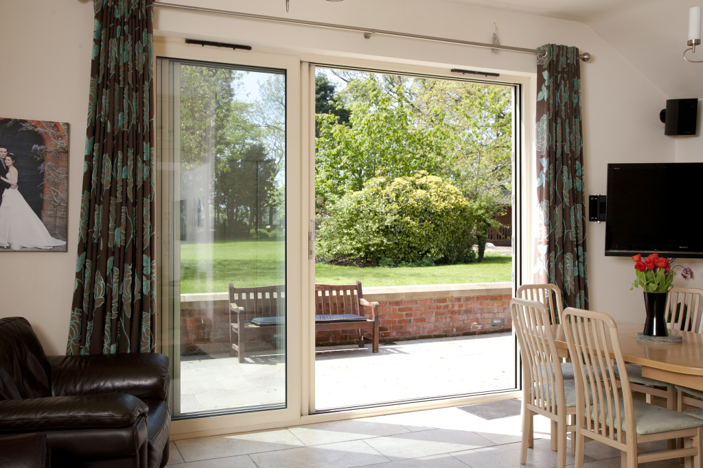 Internal shot of sliding patio doors with garden and patio outlook