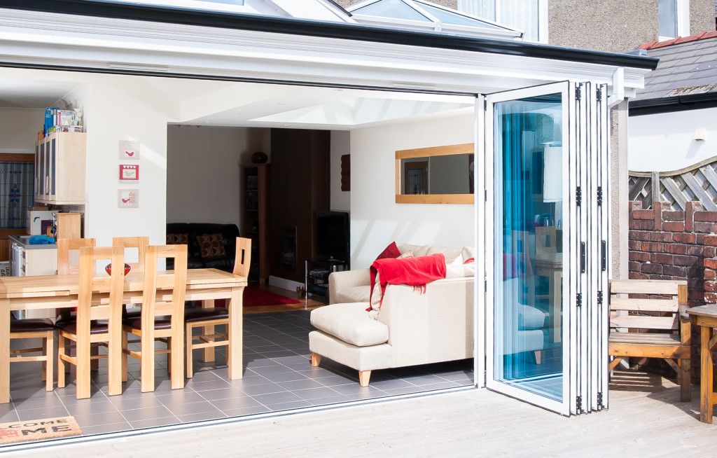 White uPVC Bi-Fold Doors fully open on a new extension