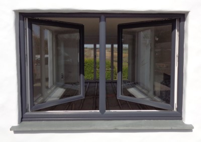 Kommerling tilt and turn window in anthracite grey. In 'turn' position